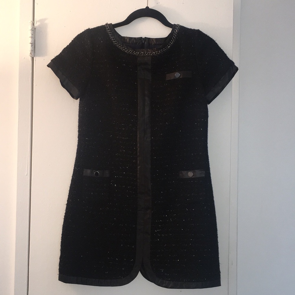 Black mini dress looks very “Chanel.”